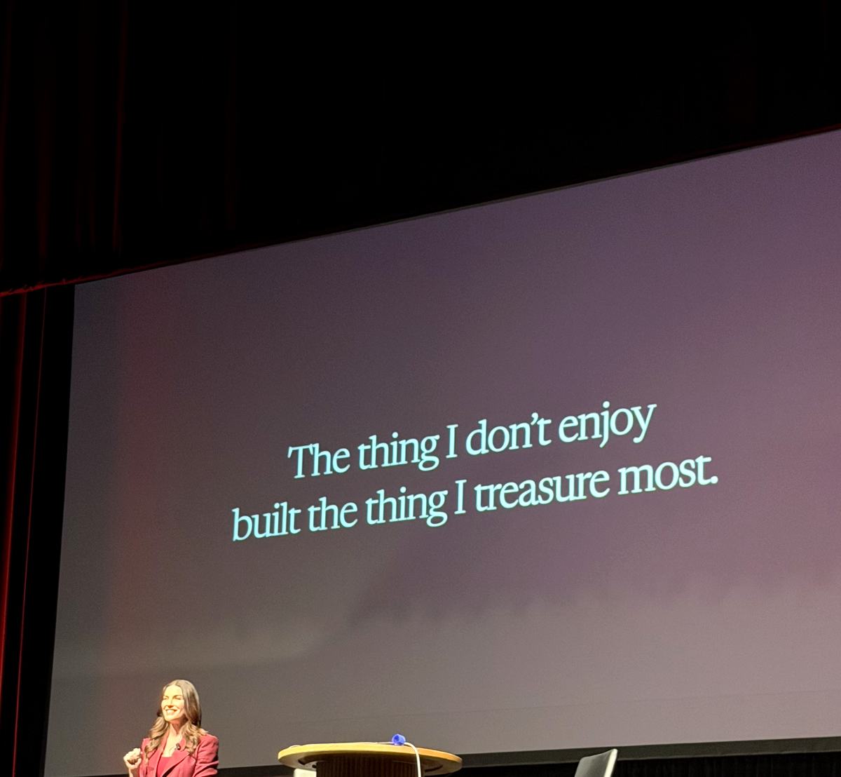Amy Porterfield on stage with a slide reading I do not enjoy creating content for social media