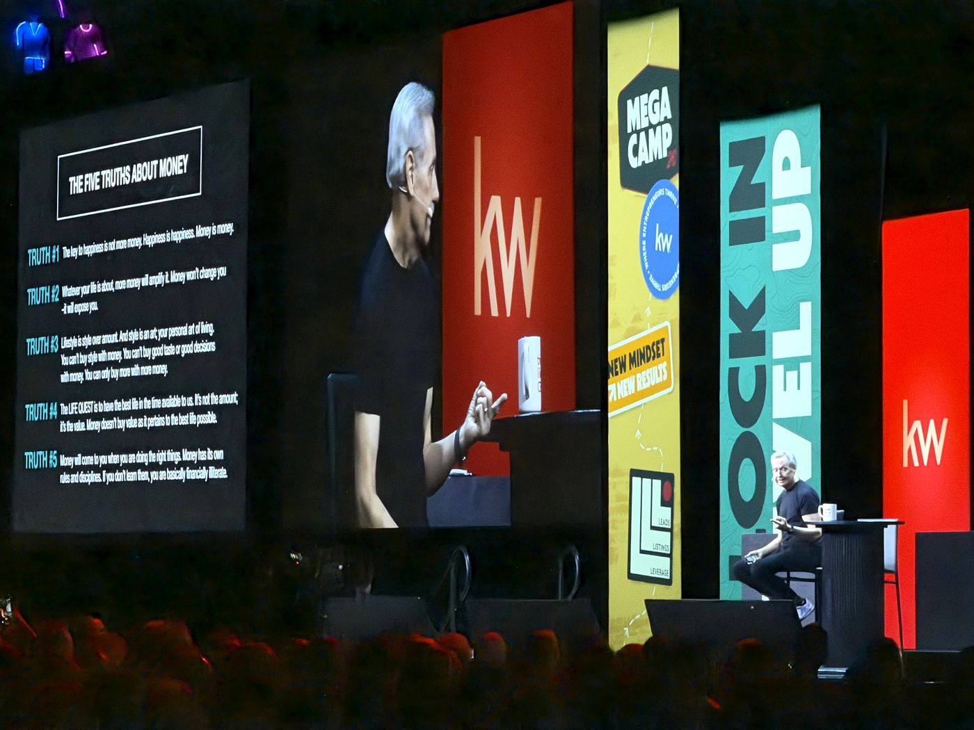 The Five Truths About Money slide on the main screen with Gary Keller on stage