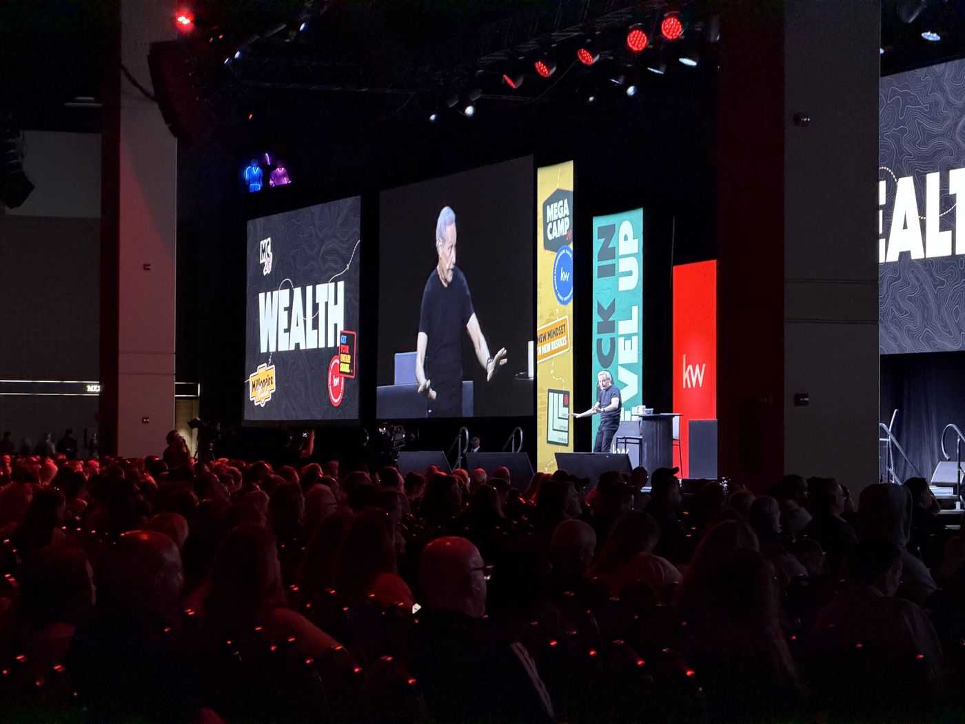 The WEALTH title slide on the main screen at Mega Camp 2026 with a full room of agents